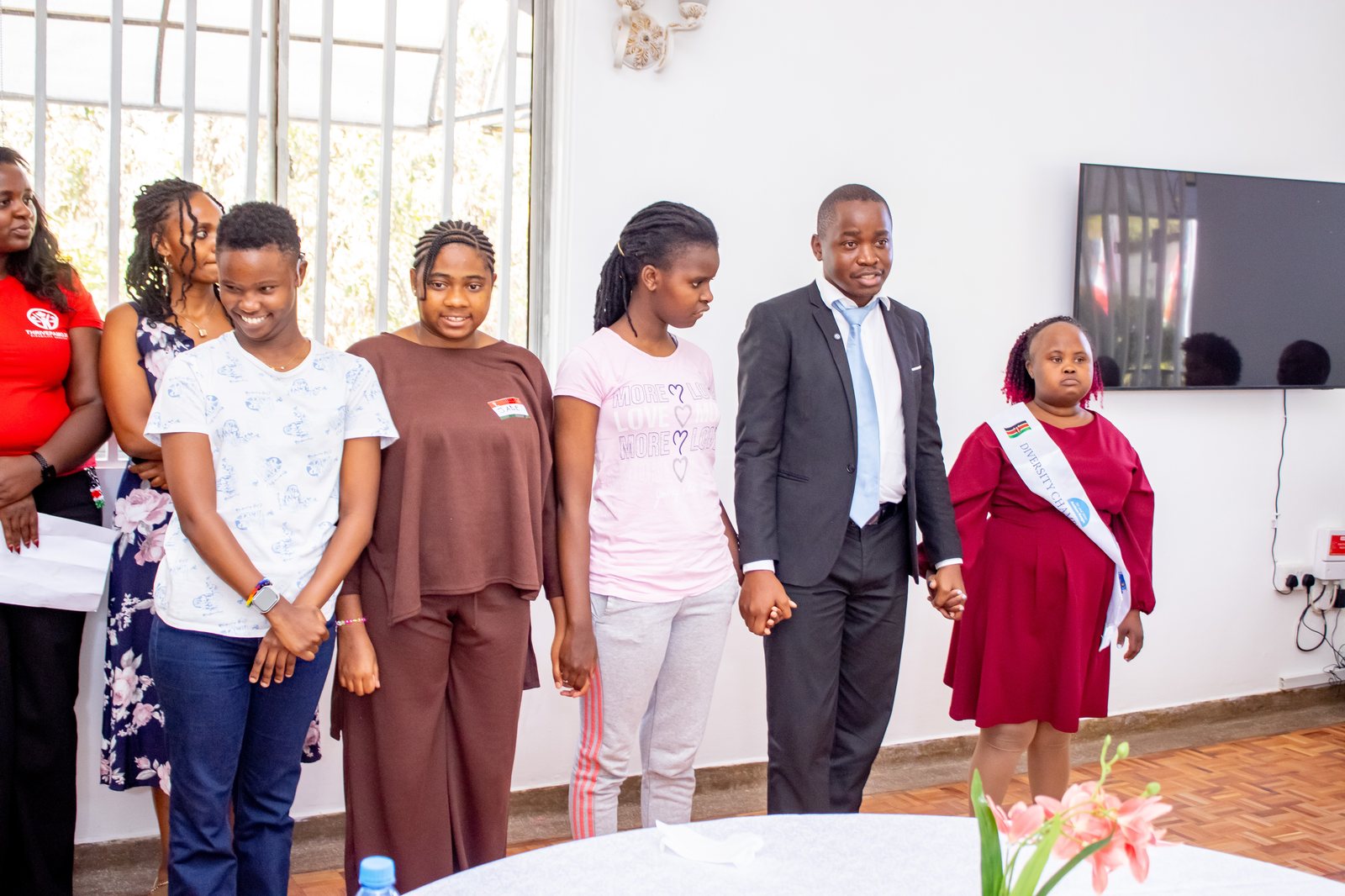 Thrive Pamoja participants holding hands together